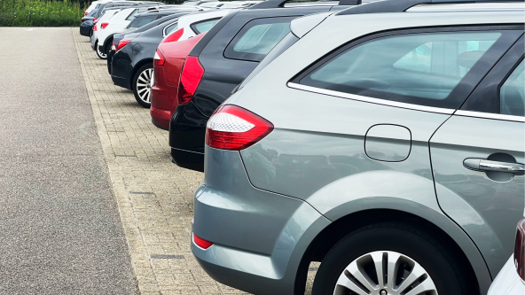 Diagonal view of a lineup of various cars parked in a row, illustrating diversity in choices and options