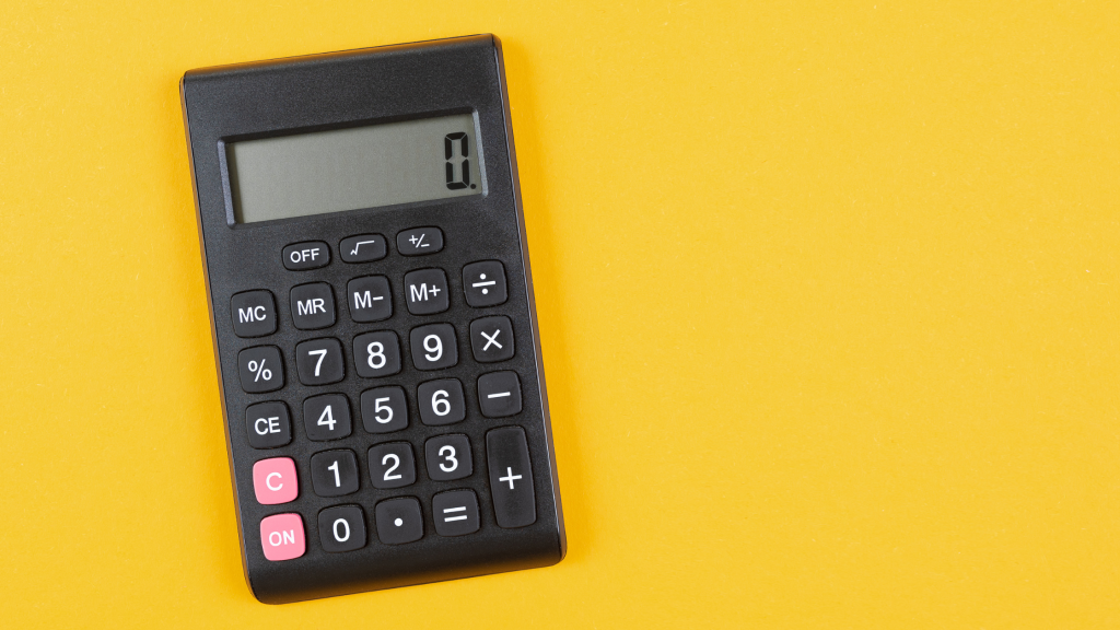 A black calculator with a digital display is set against a bright yellow background